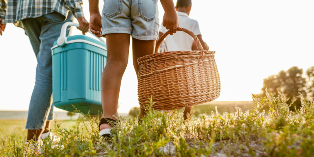 Black,happy,mother,with,her,sons,walking,with,bags,on