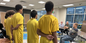 Youth at a local juvenile detention center present their ideas for an aftercare plan.