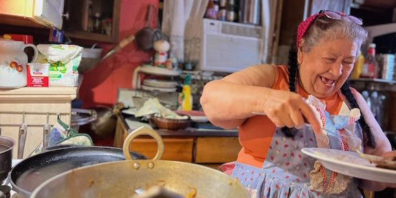 Olga preparing dinner for Shared Table guests