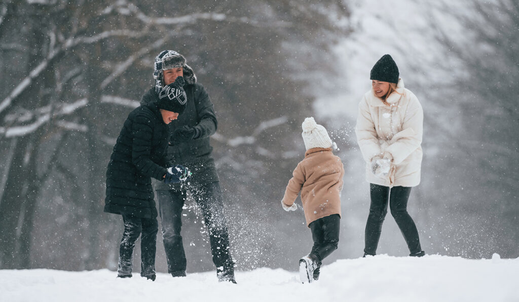 Family playing in the snow