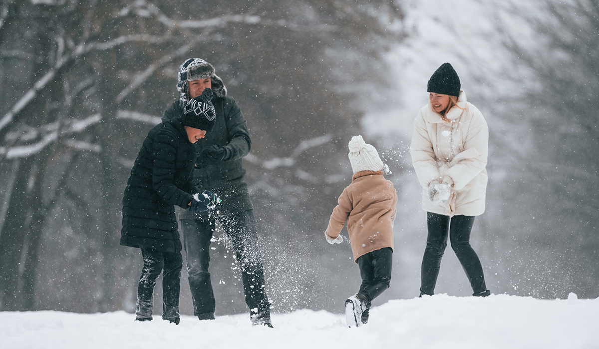 Family playing in the snow